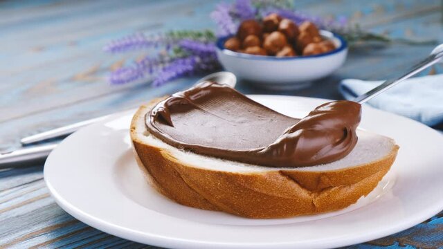 Spreading hazelnut cream on bread, chocolate nut butter