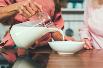 Cincematic image of a senior woman and her daughter baking and preparing food in her beautiful kitchen