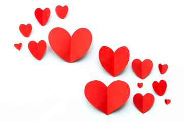 Valentine's Day background. Red paper hearts on a white background. Bright colorful hearts for postcards. - 404883314