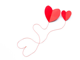 Valentine's Day background. Red paper hearts connected by a thread on a white background, isolated. - 404883542