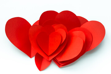 Valentine's Day background. Red paper hearts are collected in a handful, isolated on a white background. - 404883567
