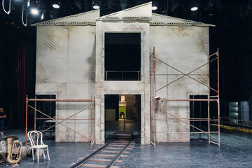Theater decoration of a house facade with requisites, props and equipment on the stage