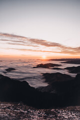Fototapeta na wymiar Sunset and sea of clouds on the mountain peak.