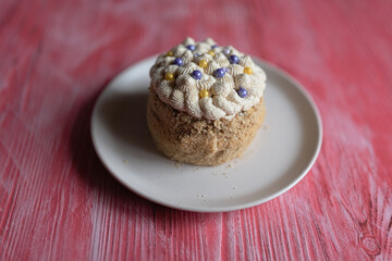 Homemade sponge cake on a pink wooden background.