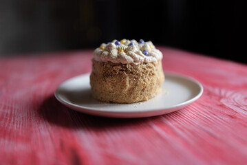 Homemade sponge cake on a pink wooden background.