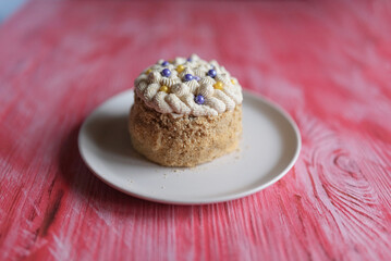 Homemade sponge cake on a pink wooden background.