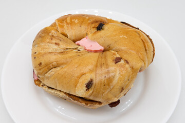 A New York Style Cinnamon Raisin Bagel Filled with Strawberry Cream Cheese