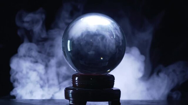 Magical fortuneteller's glass ball for predicting and telling the future. Smoke around.