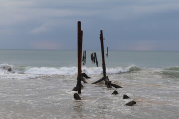 The old wooden bridge and sea wave on the beach  background at Khao Pilai, Phangnga, Thailand