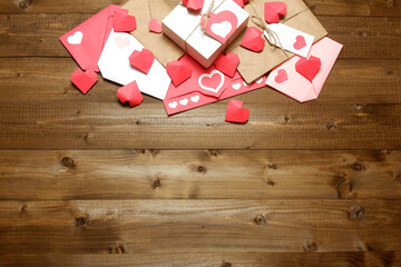 Love, Valentine's, women's day, relations, romantic template from gifts and love letters, colored and wrapped in craft paper, tied with twine with bows and labels, hearts on wood background