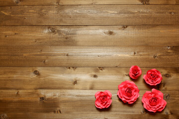 Few handmade red paper roses on brown wooden planks background. Love, Valentine's, mother's, women's day, relations, romantic, wedding template