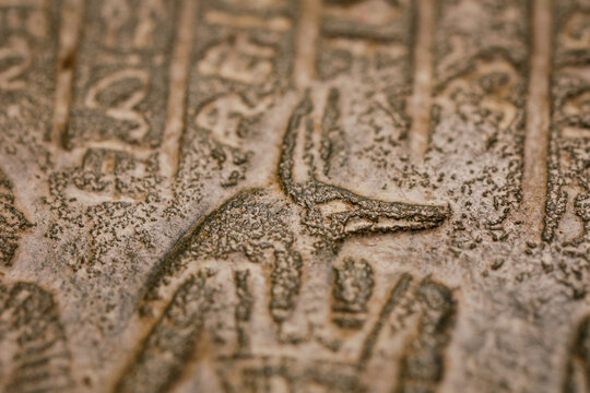Shallow depth of field (selective focus) and close up footage with Egyptian hieroglyphs on a historic replica.