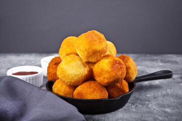 Potato croquettes balls on the iron pan and dips sauces