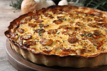Delicious homemade mushroom pie on wooden table, closeup