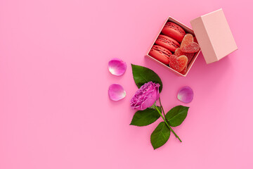 Festive composition for valentine's day and mother's day. Pink rose, box with macaroons