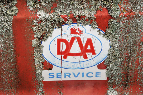 Old Dominion Automobile Association Sticker On A Car Door Covered With Lichen