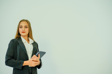 Caucasian business woman wearing suit and carrying computer notebook on white background cope space