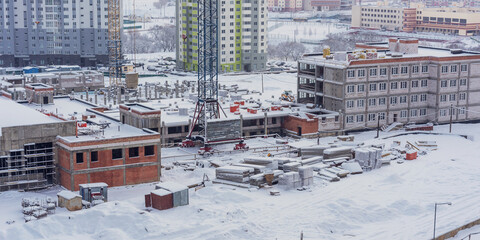 Frozen construction site covered with layer snow
