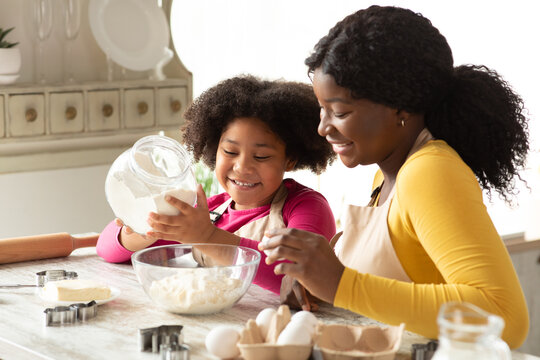 Cute Little Black Girl Baking In Kitchen With Her Mom, Cooking Pastry
