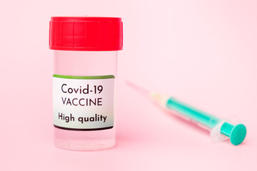 High quality Covid-19 vaccine in the bottle and disposable syringe for injection on the pink background. Prevention of coronavirus, Sars-Cov-2.