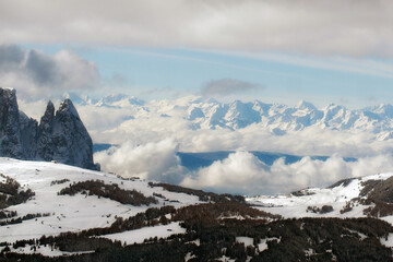 Mountain winter ski resort scenery. Snowy picks, skiing slopes and coniferous forest. Italy, Dolomites