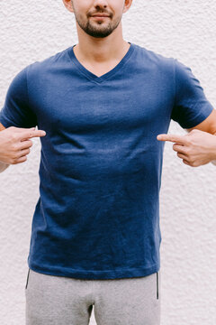 Man Wearing Blue T-shirt Mockup Outdoors. Male In Blank Blue T-shirt V Collar, Front View Outdoors. Design Men T Shirt Template And Mock-up For Print 