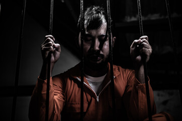 Asian man desperate at the iron prison,prisoner concept,thailand people,Hope to be free,Serious...
