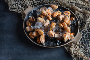 Close-up of frozen peeled mussel meat on crushed ice