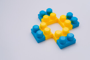 Yellow blue blocks cross figure with copy space