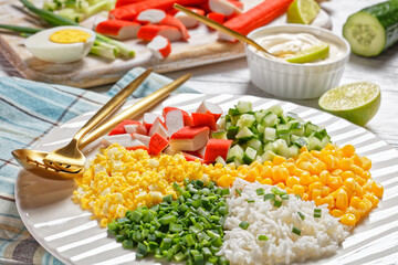 Crab salad of surimi sticks on a white plate