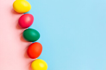 colorful easter eggs on pink background with copy space. Easter background