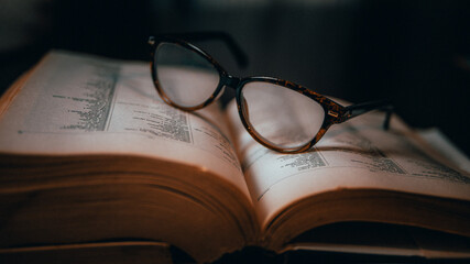 glasses  on an old book