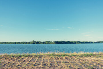 Blue cloudless sky, Lake, grassy track, landscape