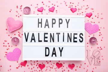 Text Happy Valentines Day with hearts, candles and sprinkles on pink background