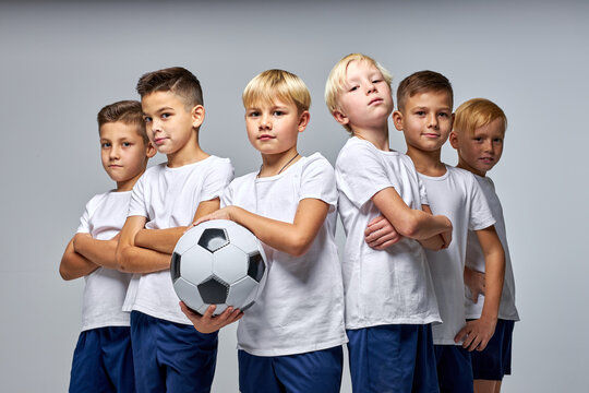 Children Soccer Team Isolated In Studio, Friendly Kids Sport Family Leisure Lifestyle Concept. Copy Space Advertisement