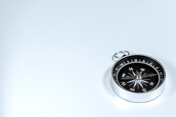 Compass close-up isolated on light background. Direction concept
