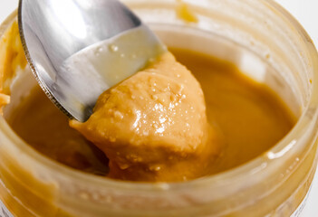 Stir with a spoonful of peanut butter in a jar. Healthy food.