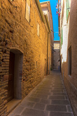 Fototapeta na wymiar A quiet residential street in the historic medieval village of Batignano, Grosseto Province, Tuscany, Italy 