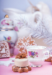 Christmass New Year decorations. Greeting card. White chocolate candy, gingerbread cookies, cup of coffe. Tender pink color. Vintage style.