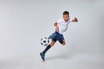 boy playing soccer, happy child, young male teenager enjoying sports game, isolated portrait, kids activities, little soccer player