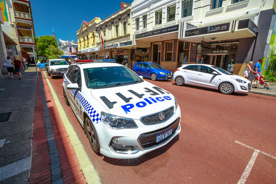 Fremantle, Western Australia, Australia - Jan 2, 2018: perspective view of an Australian police car parked in the historic center of Fremantle, among tourists, churches and old buildings.