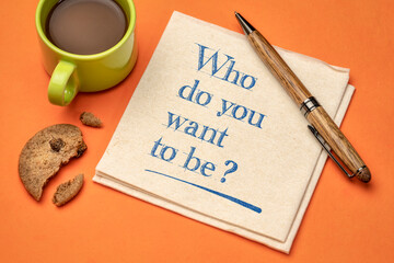 Who do you want to be? Inspirational question on napkin with a cup of coffee. Career and personal...