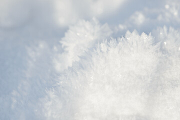 Hoarfrost background texture. Fresh ice and snow winter backdrop with snowflakes and mounds. Seasonal wallpaper. Frozen water geometrical shapes and figures. Cold weather atmospheric precipitation.