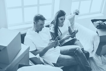 Obraz premium happy young couple looking at their smartphone screen .