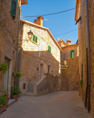 Fototapeta na wymiar A street of historic stone buildings in the village of Montorsaio in Tuscany, part of Campagnatico in Grosseto province 