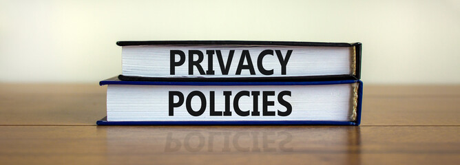 Privacy policies symbol. Concept words 'Privacy policies' on books on a wooden table. Beautiful white background. Business and privacy policies concept, copy space.
