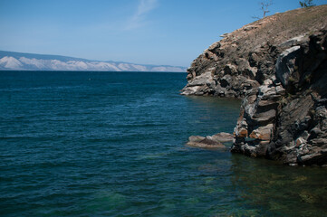Fototapeta na wymiar Turquoise water of Lake Baikal with a rock