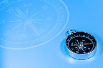 Compass on blue background with copy space. Direction concept