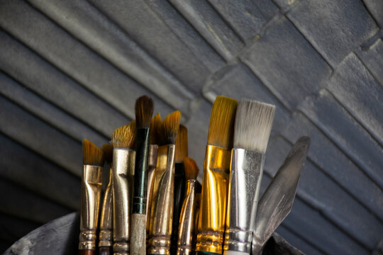 Brushes for painting on a textured, embossed background