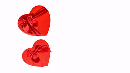 Close up of red gift boxes in form of heart on isolated white background. Concept of holidays, presents and good mood.